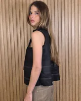 Musculosa marrón sin mangas, con cuello alto, escote en V y detalles de pespuntes blancos en contraste. Presenta pliegues y alforzas frontales.
