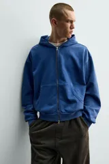 Hoodie con cierre frontal y capucha, color azul, de corte relaxed fit con interior afelpado y efecto lavado.