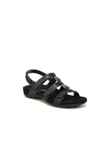 Sandalias negras con diseño de tiras ajustables con velcro, adornadas con detalles metálicos decorativos. Presentan una plantilla ergonómica con soporte de arco y suela antideslizante.