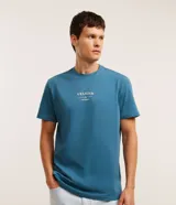 Remera de corte comfort color azul, con cuello redondo, manga corta y estampa lettering frontal con la inscripción 'Velejar Atlántico'.
