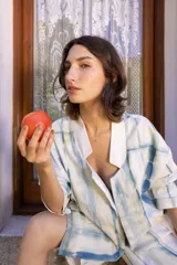 Conjunto de dos piezas compuesto por una chaqueta de corte holgado con solapas y una bermuda a juego. Ambas prendas presentan un estampado tipo tie-dye en tonos azul y blanco.