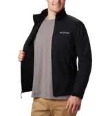 Campera softshell Columbia modelo Ascender, color negro, con tecnología Omni-Shield repelente al agua y cortavientos. Presenta cuello alto con protector de mentón, cierre frontal completo, bolsillo en el pecho y bolsillos laterales con cremallera, además de puños y dobladillo ajustables.