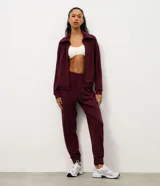 Pantalón deportivo tipo jogger color bordó, confeccionado en tejido de modal con poliéster y elastano. Presenta cintura fija, recortes estratégicos en el diseño y terminación ajustada en la botamanga.