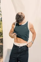 Musculosa de tejido waffle color verde british con cuello y sisas ribeteadas en blanco. Presenta un pequeño bordado en el frente.