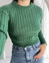 Sweater verde de punto canalé, con cuello redondo y mangas largas.