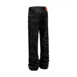 Pantalón de denim negro con acabado encerado, corte acampanado y diseño decorado con rombos formados por pedrería brillante en toda la superficie.