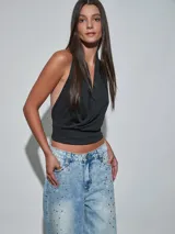 Top negro de diseño cruzado en el frente, con cuello halter y espalda descubierta.