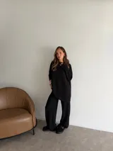 Buzo de cuello redondo y manga larga, confeccionado en tejido de viscosa con textura acanalada en color marrón chocolate. Presenta un corte holgado y relajado.