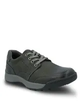 Zapato casual Hush Puppies modelo Duran, confeccionado en cuero de color gris oscuro. Presenta un diseño de cordones, cuello acolchado para mayor confort y suela de goma resistente con una ligera elevación en el talón.