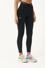 Calza deportiva negra de tiro medio, confeccionada en poliamida y elastano.