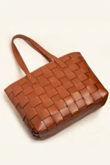 Cartera tote de cuero marrón con diseño trenzado a mano, de formato rectangular y doble asa de hombro.