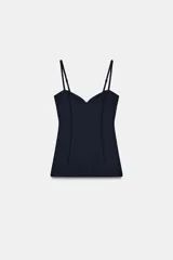 Top de escote en pico con tirantes finos ajustables. Presenta un diseño entallado con costuras verticales decorativas en el frente y bajo recto.