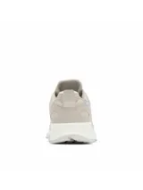 Zapatilla de senderismo Columbia Peakfreak Hera, color beige claro (Soft Taupe), con detalles en gamuza y malla transpirable. Presenta entresuela gruesa blanca con suela exterior dentada para tracción y tecnología impermeable OutDry™.