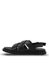 Sandalias negras de cuero con tiras cruzadas, tachas metálicas aplicadas y suela de EVA. Cuentan con tira ajustable en el talón con hebilla y ribete con tachas en la plataforma.