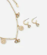 Conjunto de collar corto con cadena palito y colgantes de flores diversas, y caravanas aro con colgante de flor cristal lechoso, con baño light gold.