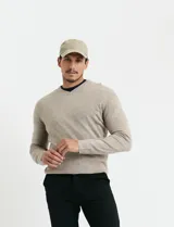 Sweater de punto con escote en V y manga larga, confeccionado en tejido acrílico con textura suave.