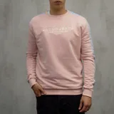 Buzo deportivo rosado de algodón con cuello redondo y mangas largas con franjas celestes. Estampado frontal con el texto "Duxon Jeans Los Angeles Est 1992".