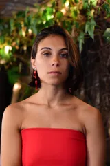 Caravanas colgantes con base de strass y estructura de cuentas en tonos rojos de diversas formas y texturas.