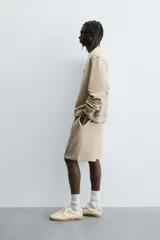 Sudadera de algodón color beige claro, corte relajado, cuello redondo y manga larga. Presenta bordado en relieve en el frente con texto en cursiva de color cobre.