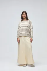 Buzo de tejido de punto con diseño de rayas horizontales en tonos beige y blanco, cuello redondo, hombros caídos y mangas largas.