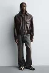 Zueco de piel con pelo con estampado de vaca en blanco y negro. Presenta una horma redonda y una suela de goma negra con volumen.