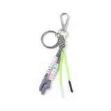 Llavero con aro metálico, mosquetón plateado, cordón trenzado blanco y negro, cordón verde neón y dije con forma de manos grises con cuentas con letras formando la palabra "EXTRA LARGE".