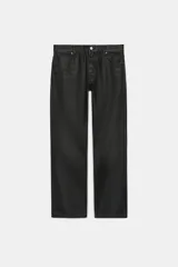 Jeans de tiro bajo y corte recto holgado, con efecto encerado en color negro, cinco bolsillos y trabillas para cinturón. Cierre frontal con cremallera y botón metálico.