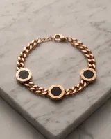 Pulsera de acero color oro rosa con cadena de eslabones y dijes circulares con detalles en negro y números romanos grabados.