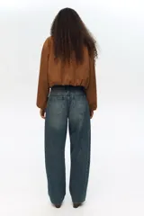 Jean de cinco bolsillos en denim de algodón, de cintura estándar, diseño curvo y corte holgado con efecto desgastado.