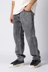 Jean de corte mom oversize, color negro lavado, con diseño de cinco bolsillos y cierre frontal con botón y cremallera.