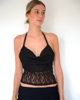 Top de encaje negro con escote drapeado y breteles finos tipo halter.