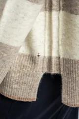 Sweater de punto con diseño de rayas horizontales anchas en color bordó y beige. Presenta cuello redondo con detalle de lurex, mangas largas y puños y ruedo acanalados.