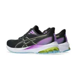 Championes de running Asics modelo GT-1000 12, color negro con detalles en violeta, amarillo neón y suela azul. Presentan tecnología FlyteFoam en la entresuela para mayor amortiguación y soporte.