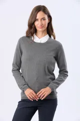 Buzo tejido en hilo de algodón color gris, con cuello redondo clásico y manga larga.